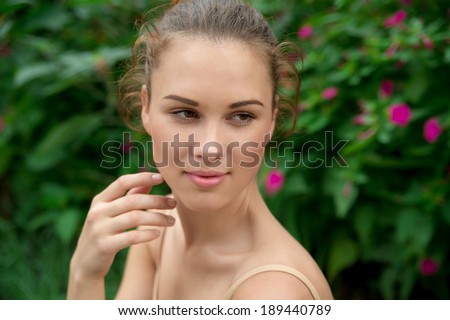 Beautiful young adult woman with clean fresh skin  on green background, pure beauty, natural beauty, garden
