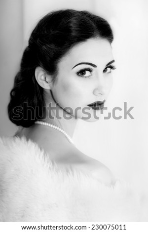 Retro style portrait of attractive young model with sad facial expression.  Black and white portrait.