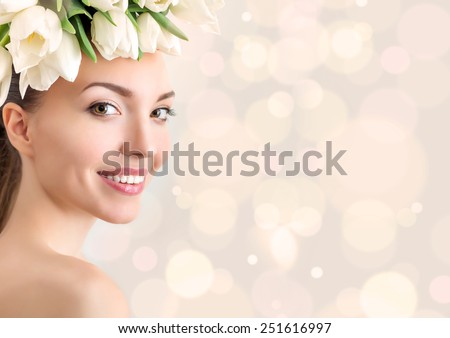 Portrait of beautiful young woman with flowers in hair. Bokeh, color toning. Place for text