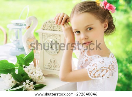 Little smiling girl with big watch. People, time management and children concept. Vintage style. Facial Expression.