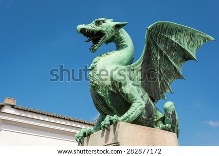 Green dragon on the dragon bridge in Ljubljana on a sunny day