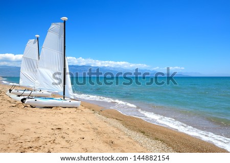 Sail yachts on the beach on Ionian Sea at luxury hotel, Peloponnes, Greece
