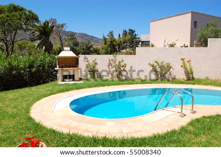 Grill at swimming pool by luxury villa, Crete, Greece