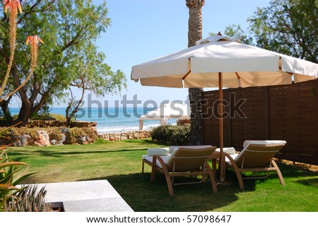 Sunbeds at the beach of luxury villa, Crete, Greece