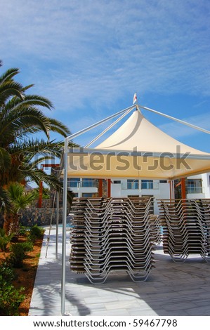 Set of sunbeds under hut at luxury hotel, Crete, Greece