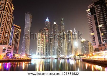 DUBAI, UAE - SEPTEMBER 11: The Cayan Tower in night illumination at Dubai Marina on September 11, 2013 in Dubai, UAE. It is world\'s tallest high rise building with a twist of 90 degrees.
