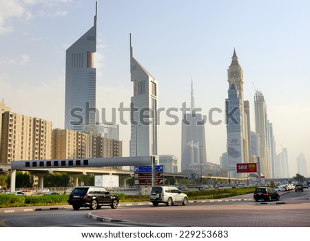 DUBAI, UAE - SEPTEMBER 8: The Dubai cityscape and Emirates towers on September 8, 2013 in Dubai, UAE. In the city of artificial channel length of 3 kilometers along the Persian Gulf.