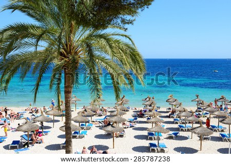 MALLORCA, SPAIN - MAY 28: The tourists enjoiying their vacation on the beach on May 28, 2015 in Mallorca, Spain. Up to 60 mln tourists is expected to visit Spain in year 2015.