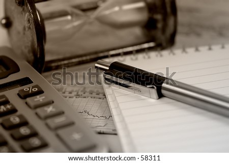 Hourglass, Stock Charts, Caculator and a Pen in Sepia Tone