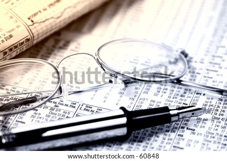 Photo of Stock Quotes, Eyeglasses and a Pen With Blur Effect