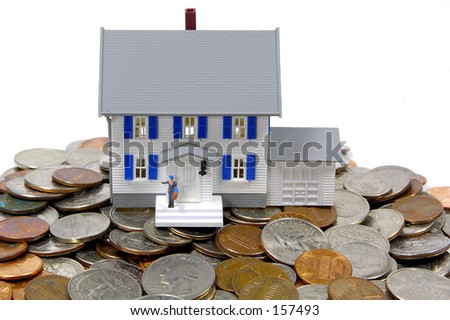 Miniature House and Change.  Home Savings / Mortgage Concept.  See Portfolio For Similar Concepts