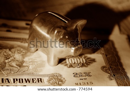 Photo of Stock Certificates and a Piggy Bank