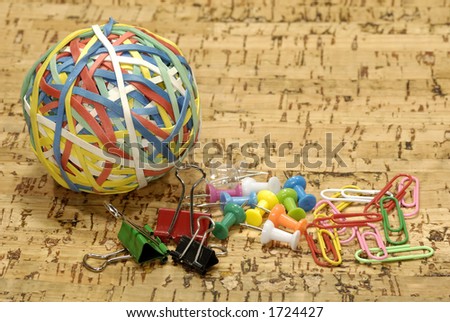 Rubberband Ball with Paperclips and Thumbtacks - Office Supplies Concept