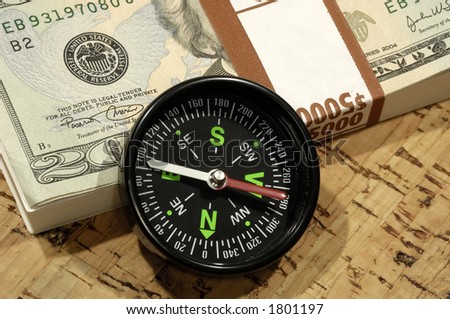 Photo of a Compass and Cash - Market Direction Concept