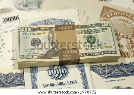 Photo of Money on Top of Stock Certificates - Investing Concept