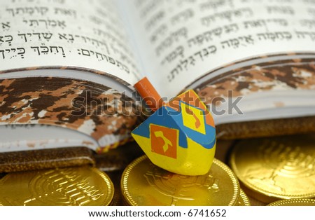 Dreidel with Gelt and a Hebrew Bible - Passover Related
