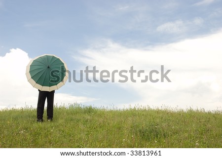 Business protection conception businessman with umbrella