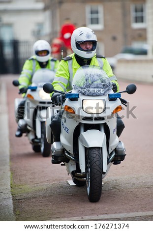 LONDON - FEB 17: Special Escort Group Police motorcyclists on the street near Buckingham Palace on Feb. 17, 2012 in London, UK. The unit provides motorcycle escorts for members of the Royal family.