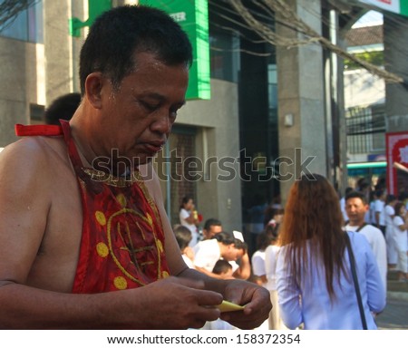 PHUKET, THAILAND - OCTOBER 11: A traditional Mah Song or warrior in the street procession of the Phuket Vegetarian Parade in Phuket Town, Phuket, Thailand on the 11th October, 2013.