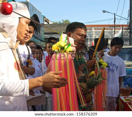 PHUKET, THAILAND - OCTOBER 11: A traditional Mah Song or warrior in the street procession of the Phuket Vegetarian Festival in Phuket Town, Phuket, Thailand on the 11th October, 2013.