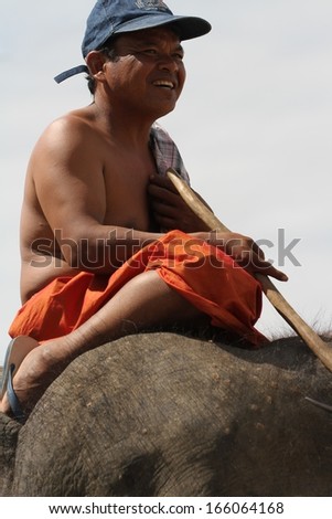 SURIN, THAILAND - NOVEMBER 16: A mahout astride his elephant at the Elephant Roundup Festival held in Surin, Thailand on the 16th November, 2013.