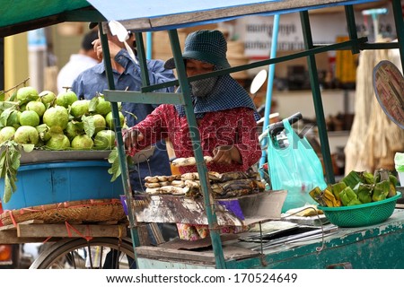 SIEM REAP, CAMBODIA - NOVEMBER 27: A typical Cambodian street food hawker preparing food in Siem Reap, Cambodia on the 27th November, 2013.