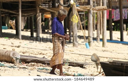 PHANG NGA, THAILAND - MARCH 11: A Moken sea gypsy in his village  going about daily life on Koh Surin Tai in the Surin Islands National Park, Phang Nga, Thailand on the 11th March, 2014.