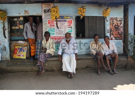 KANDY, SRI LANKA - FEBRUARY 19: A typical scene of Sri Lankan men sitting outside a local shop in the countryside of Kandy, Sri Lanka on the 19th February, 2014.