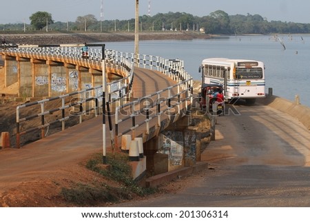 DAMBULLA, SRI LANKA - FEBRUARY 15: The divided road in case of flooding at Amaya Lake, Dambulla, Sri Lanka with traffic on it on the 15th February, 2014.