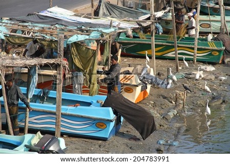 COLOMBO, SRI LANKA - MARCH 1: Fishing boats on the muddy banks in the lagoon near the fish markets of Negombo, near Colombo, Sri Lanka on the 1st March, 2014.