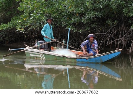 BANGKOK, THAILAND - MAY 14: Local Thai fishermen in their canoe amongst the mangrove forest near Tabla Mu Pier on the Khao Lak coastline, Bangkok, Thailand on the 14th May, 2014.