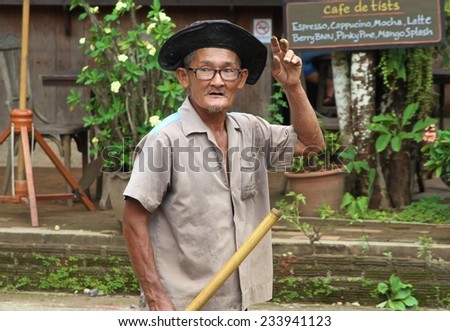 CHIANG MAI, THAILAND - AUGUST 31: A local workman digging new drainage ditches on the side of the road in Pai, north of Chiang Mai, Thailand on the 31st August, 2014.