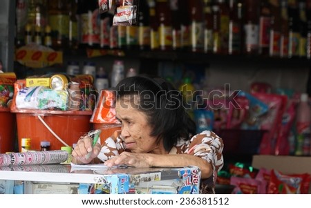 KANCHANABURI, THAILAND - SEPTEMBER 3: An elderly shop keeper in the town of Kanchanaburi, Thailand on the 3 September, 2014.