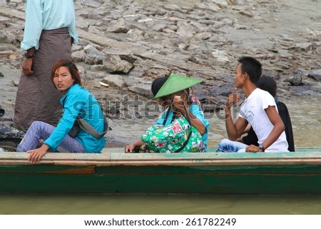 MYITKYINA, MYANMAR - NOVEMBER 6: Local Burmese people on a boat near the town of Myitkyina, Myanmar on the 6th November, 2012.