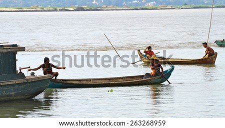MANDALAY, MYANMAR - NOVEMBER 7:
Local villagers from the shanty town in boats fishing in the Irrawaddy River  town of Mandalay, Myanmar on the 7th November 2012.