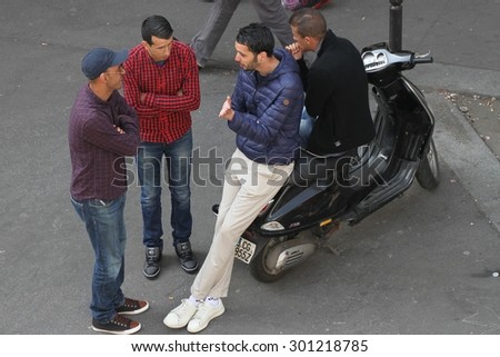 PARIS, FRANCE - APRIL 24:\
A group of men chatting in the streets of the 19th Arrondissement of Paris, France\
on the 24th April, 2015.