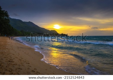 Sunset over the Beau Vallon Beach on the island of Mahe, Seychelles. Beau Vallon Beach is well-frequented and is possibly the most popular beach on the island. Photo stock © 