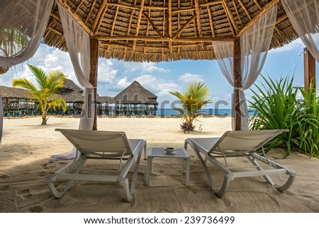 Beach lounge chairs and a beach bar at the shore of Indian ocean, Zanzibar, Tanzania