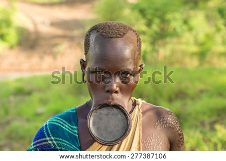 OMO VALLEY, ETHIOPIA - MAY 3, 2015 : Woman from the african tribe Surma with big lip plate.