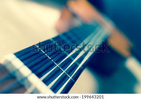 Acoustic Guitar focus to fret on fingerboard, shallow depth of field, old film processed