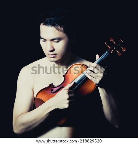 Portrait of Attractive Topless Handsome Asian male Musician plays Violin, isolated on black