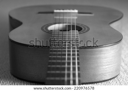 acoustic / classical guitar focus to fret on fingerboard, on the floor / shallow dept of field & B+W film processed