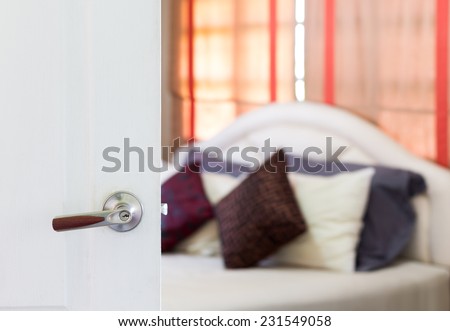 white door open to cozy bedroom , white bed, brown curtain / asian modern living style