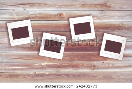 retro photo of four negative slide film frame on old wood for background