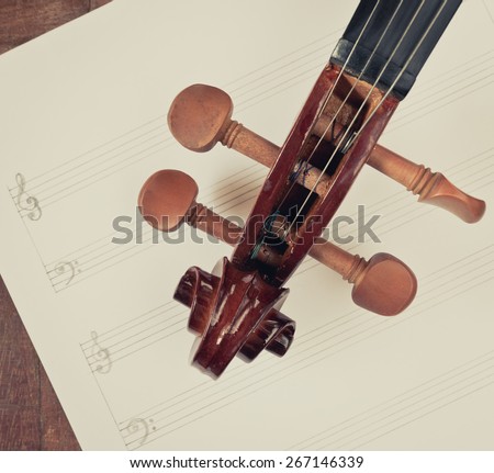 classical Violin headstock closeup on blank Music sheet + vintage filter for music composer concept background