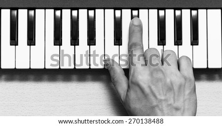 musician hand play on piano, music synthesizer keyboard / black and white processed