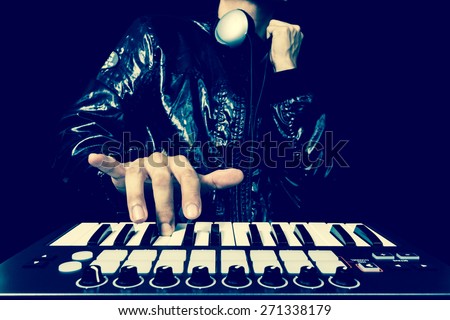 professional musician or DJ hand on studio keyboard synthesizer, isolated on black for dance , groove, remix, underground music background concept