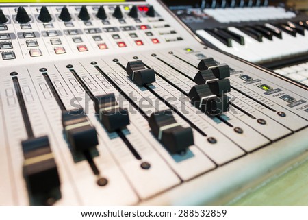 closeup photo of digital studio mixer & keyboard synthesizer for music background