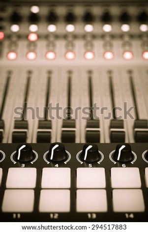 recording studio gears, broadcasting tool, mixer, synthesizer focus to knobs. shallow dept of field for music background