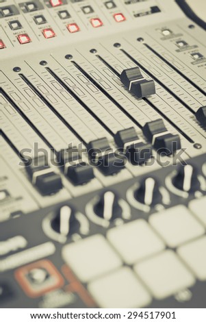 recording studio gears, broadcasting tools, mixer, synthesizer focus to fader. shallow dept of field for music background